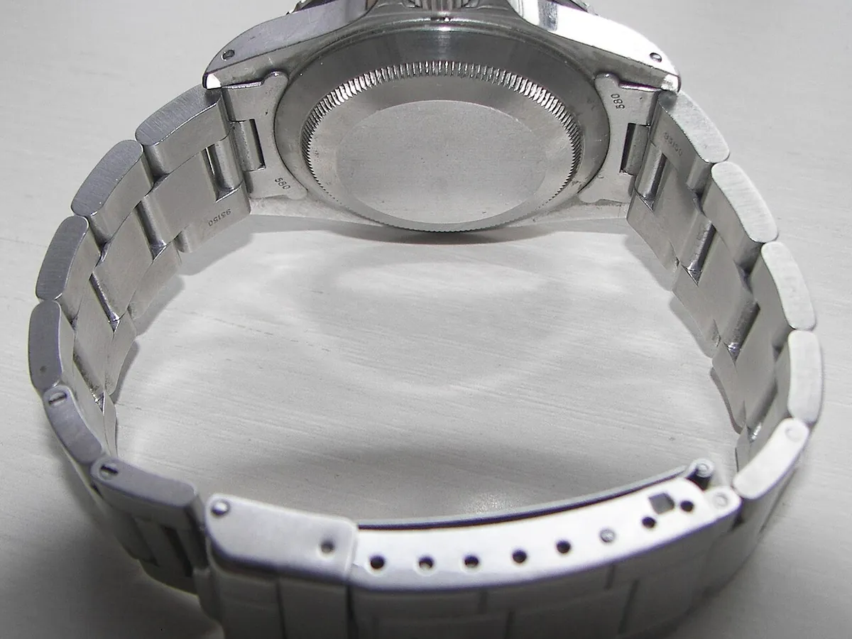 Rolex service cost begins with opening this: a solid Submariner caseback and bracelet clasp